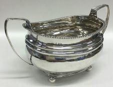 A Georgian silver sugar bowl on four ball feet. Lo