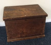 A small pine hinged top trunk. Est. £20 - £30.