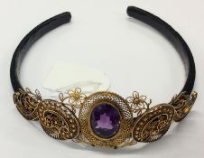 A heavy high carat gold and amethyst tiara on velv