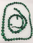 Two graduated strings of malachite beads. Est. £20