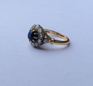 A sapphire and diamond circular cluster ring with