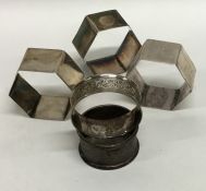 A group of five various silver napkin rings with e