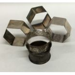 A group of five various silver napkin rings with e