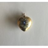 A large sapphire and diamond heart shaped locket w