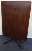 A mahogany rectangular tilt top breakfast table on