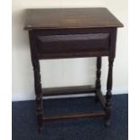 An oak hinged top side table with stretcher base.