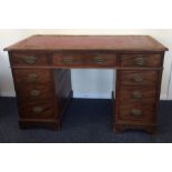 A Georgian mahogany nine drawer twin pedestal desk