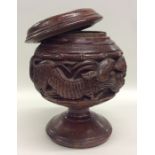 An Asian carved Treen tobacco box carved with anim
