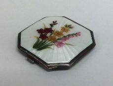 A square silver and enamel compact decorated with