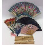 A bag containing numerous fans, chopsticks etc. Es