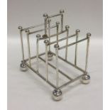 A silver five bar toast rack on ball feet. Sheffie