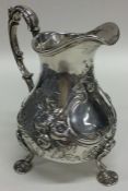 A good Georgian embossed silver cream jug decorate