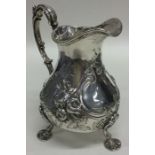 A good Georgian embossed silver cream jug decorate