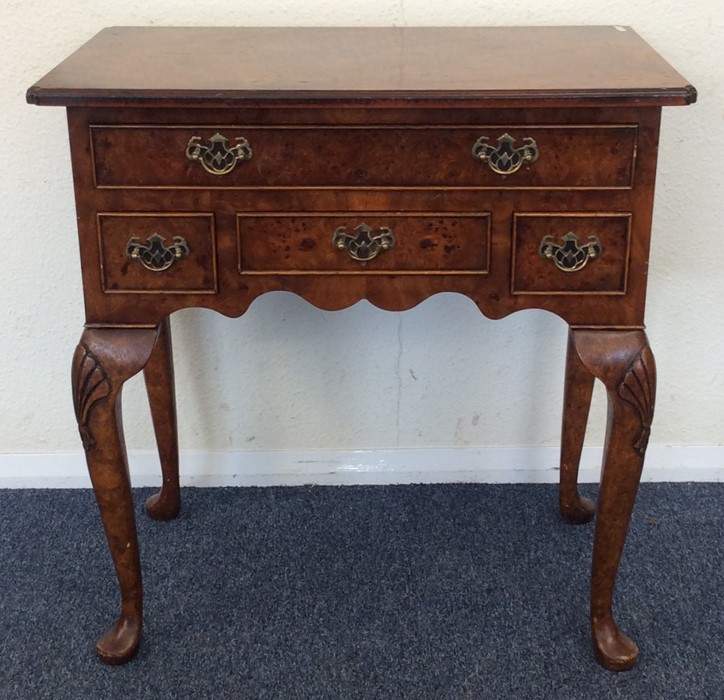 A late 20th Century four drawer lowboy on cabriole