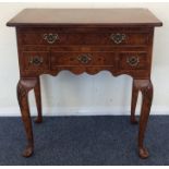 A late 20th Century four drawer lowboy on cabriole