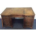 A mahogany twin pedestal desk with leather inset t