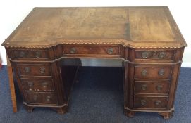 A mahogany twin pedestal desk with leather inset t