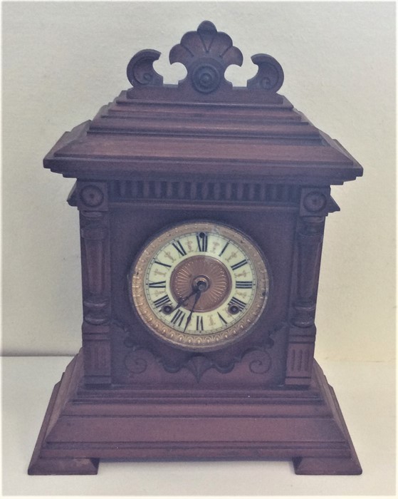 An Edwardian mahogany mantle clock with carved dec