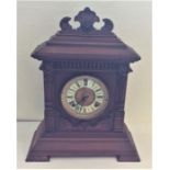 An Edwardian mahogany mantle clock with carved dec