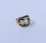 An unusual high carat gold enamel decorated ring.