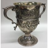 A large Georgian silver and embossed two handled t