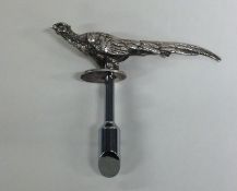 A novelty silver bottle opener in the form of a co