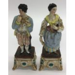 An attractive pair of gilded figures in standing p