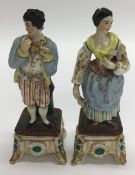 An attractive pair of gilded figures in standing p