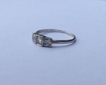 A stylish diamond and platinum three stone ring wi