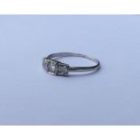 A stylish diamond and platinum three stone ring wi