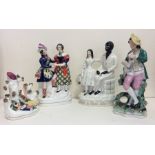 A group of four Staffordshire figures decorated in