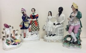 A group of four Staffordshire figures decorated in