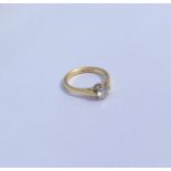 A diamond single stone mounted as a ring in two co