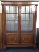 A mahogany glazed cabinet. Est. £40 - £60.