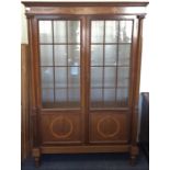 A mahogany glazed cabinet. Est. £40 - £60.