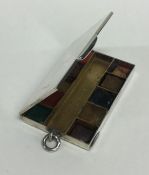 An unusual silver travelling paint box with hinged