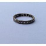 A diamond full eternity ring in white gold band. R