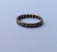 A diamond full eternity ring in white gold band. R