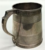 A Georgian silver tapering half pint mug with reed