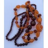 A graduated string of amber beads etc. Est. £40 -