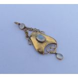A stylish gold and moonstone drop pendant with loo