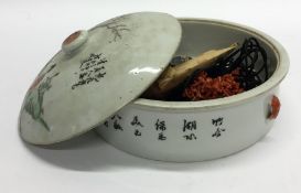 A Chinese bowl and cover decorated with figures an