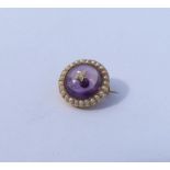 An attractive cabochon amethyst and diamond brooch