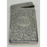 An Edwardian silver card case decorated with scrol
