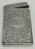 An Edwardian silver card case decorated with scrol