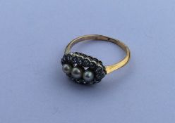 A gold and pearl oval cluster ring in 18 carat cla