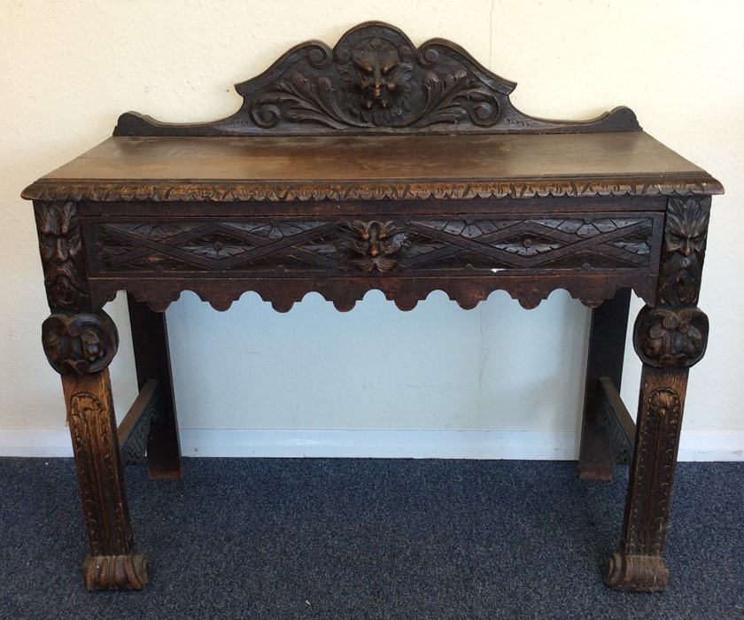 An oak carved single drawer hall table. Est. £40 -