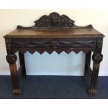 An oak carved single drawer hall table. Est. £40 -