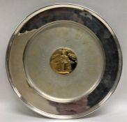A large circular silver commemorative dish decorat