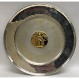 A large circular silver commemorative dish decorat